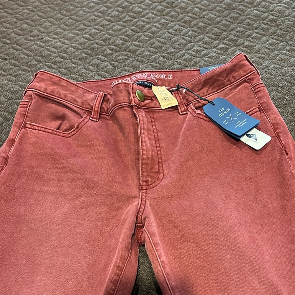 Brand new American Eagle burgundy colored high performance stretch jeans.